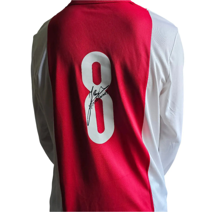 Back view showing No. 8 and Sjaak Swart's signature on a red and white football shirt.