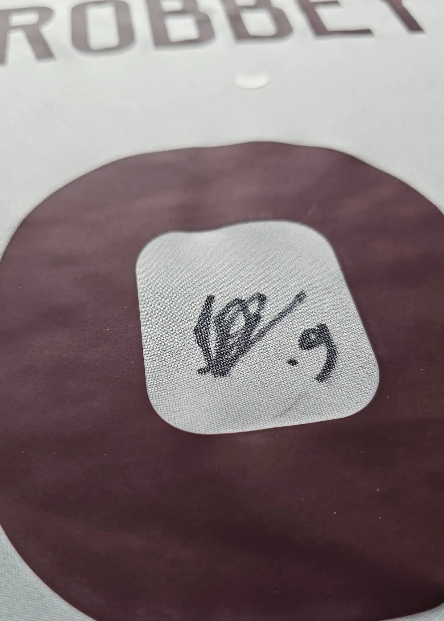 Close-up of signature detail on Brian Brobbey football shirt, showing No. 9 and signature.