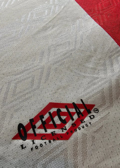Official licensed football product label on red and gray fabric.