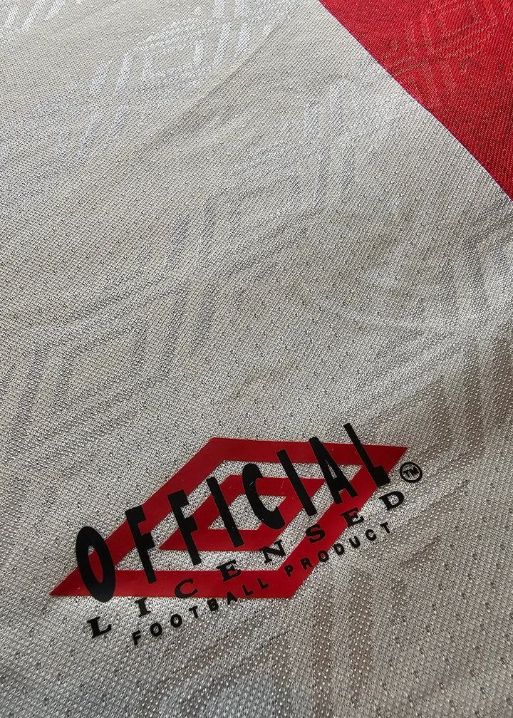 Official licensed football product label on red and gray fabric.