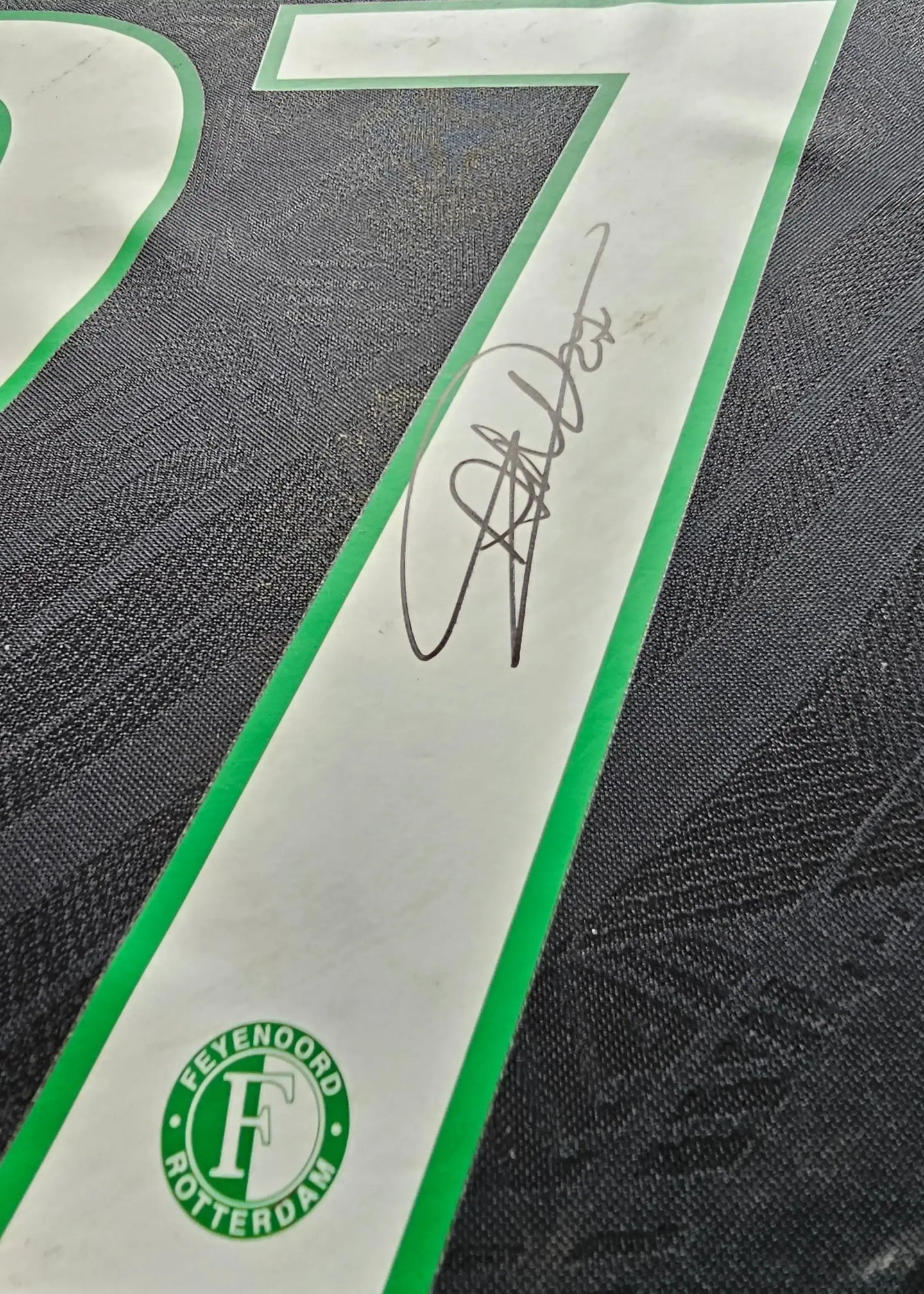 Detail view showing No. 27 and the signature of Antony Milambo on a football shirt.