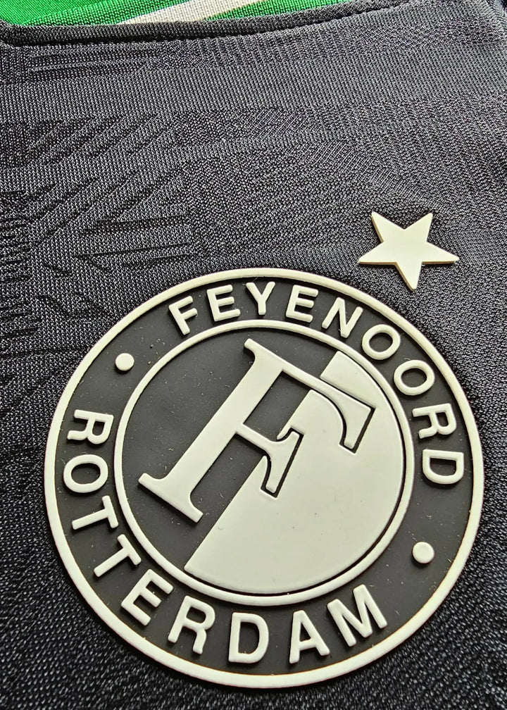 Close-up of the Feyenoord Rotterdam crest featuring an 'F' and a star above.