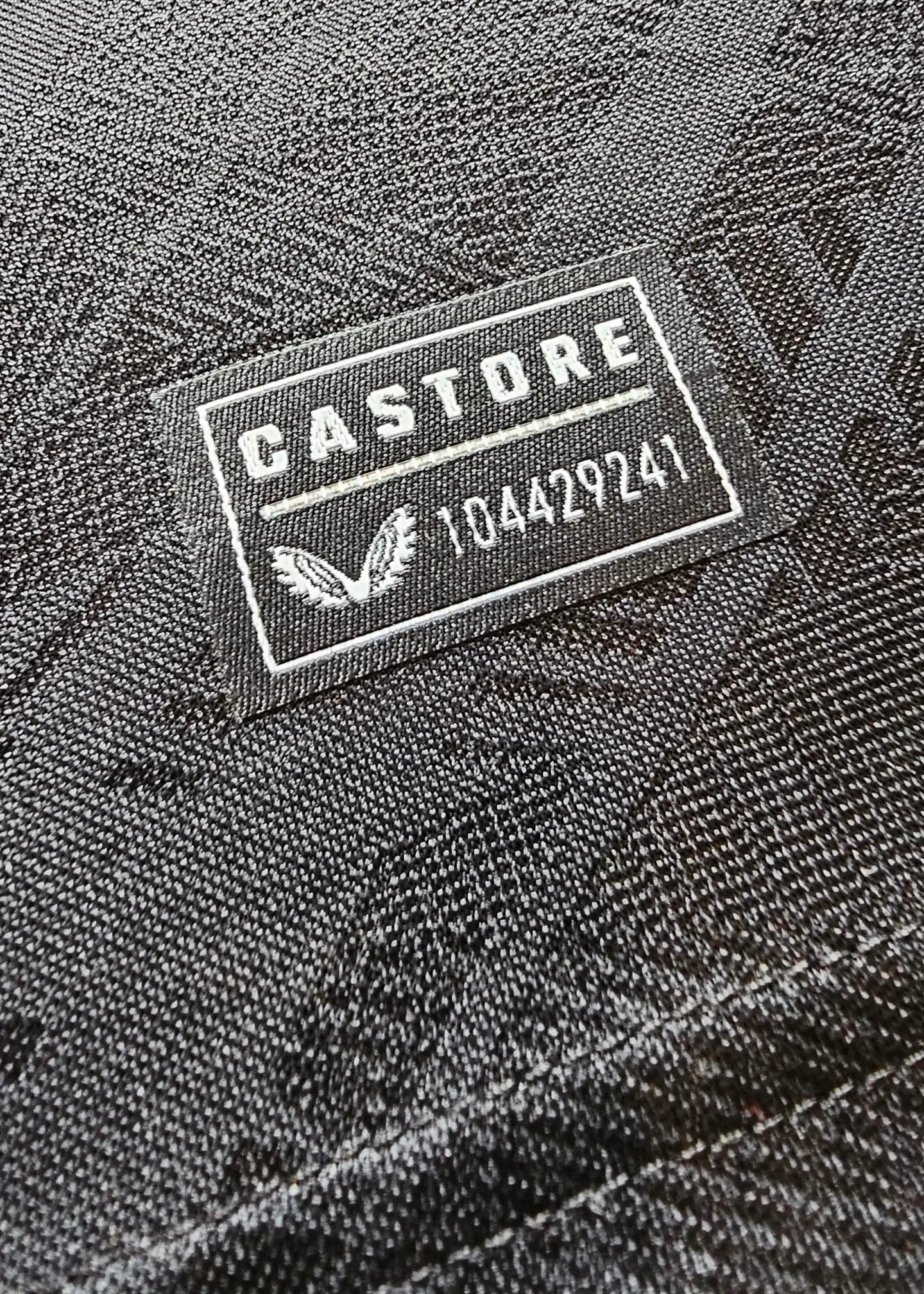 Detail showing 'CASTORE' logo and serial number on the fabric.