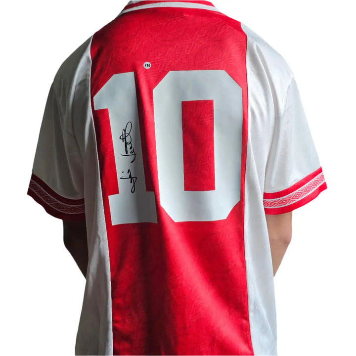 Back view showing No. 10 and signature on a red and white football shirt.
