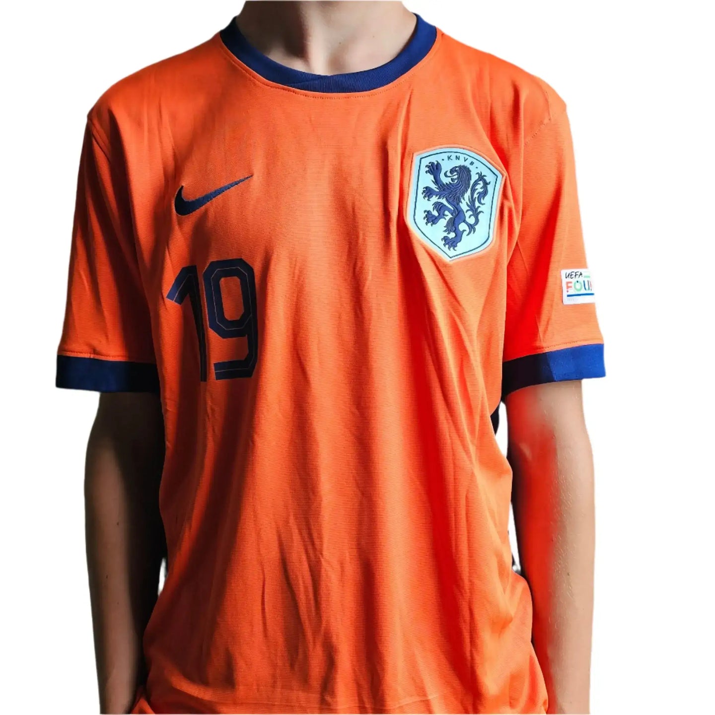Front view of orange football shirt with No. 19 and Holland crest.
