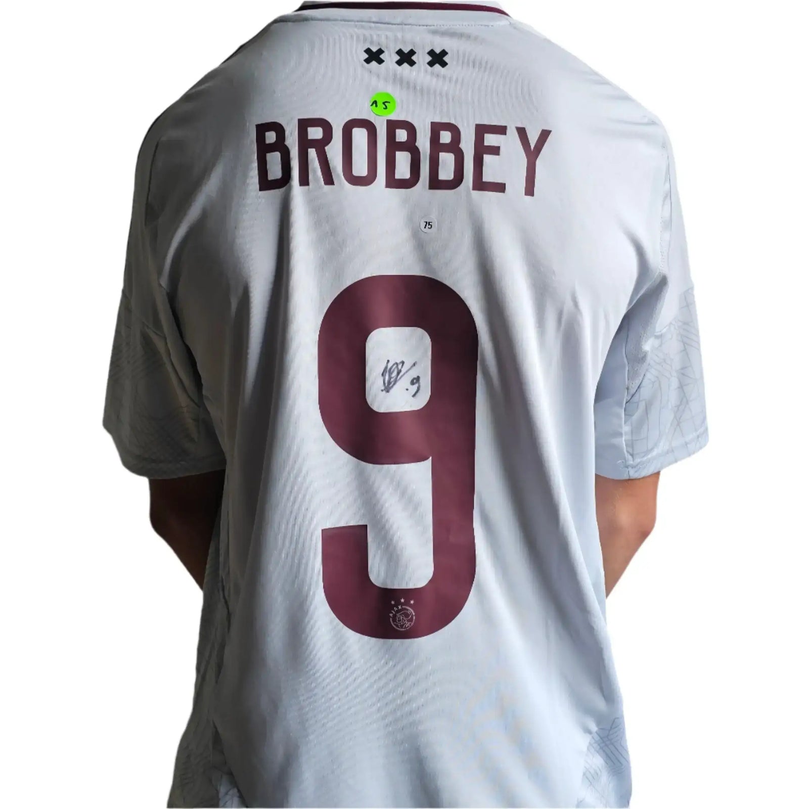 Back view showing Brobbey, No. 9, and a visible signature on the white football shirt.