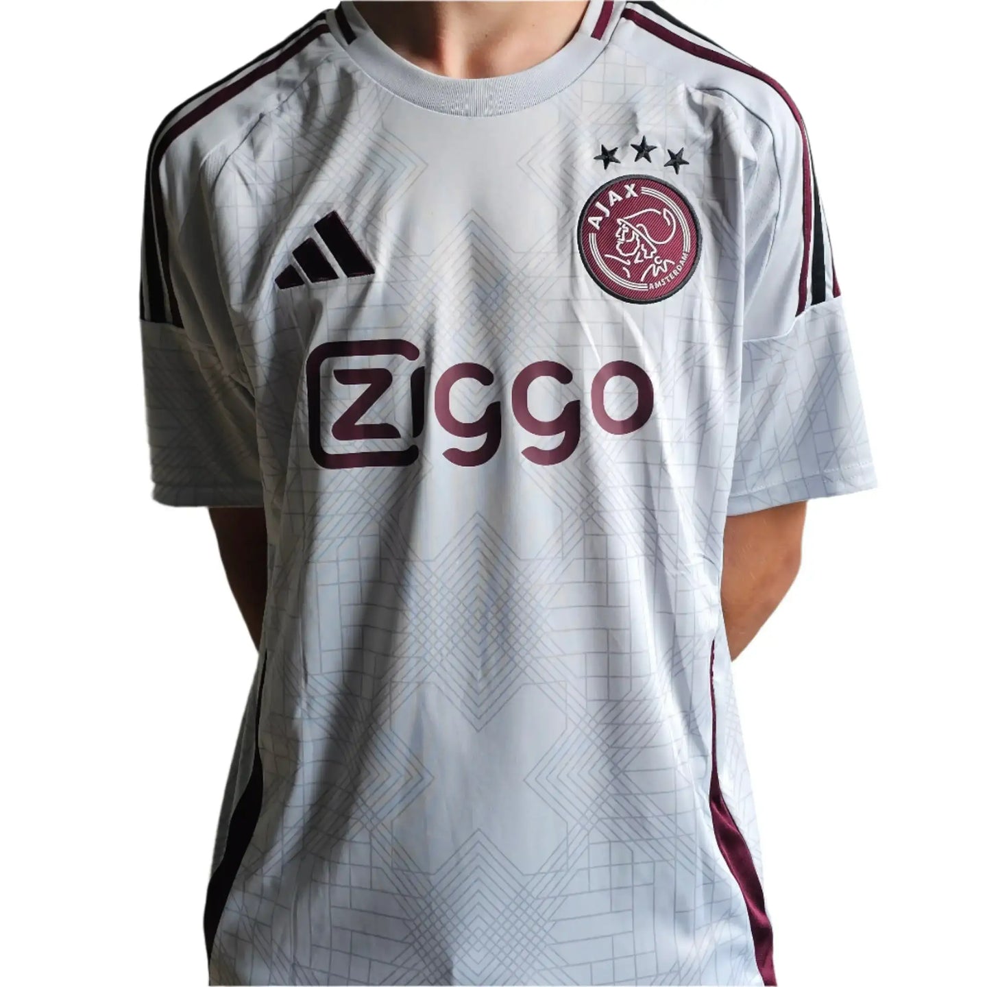 Front view of signed Ajax football shirt featuring Ziggo logo and three stars above the crest.