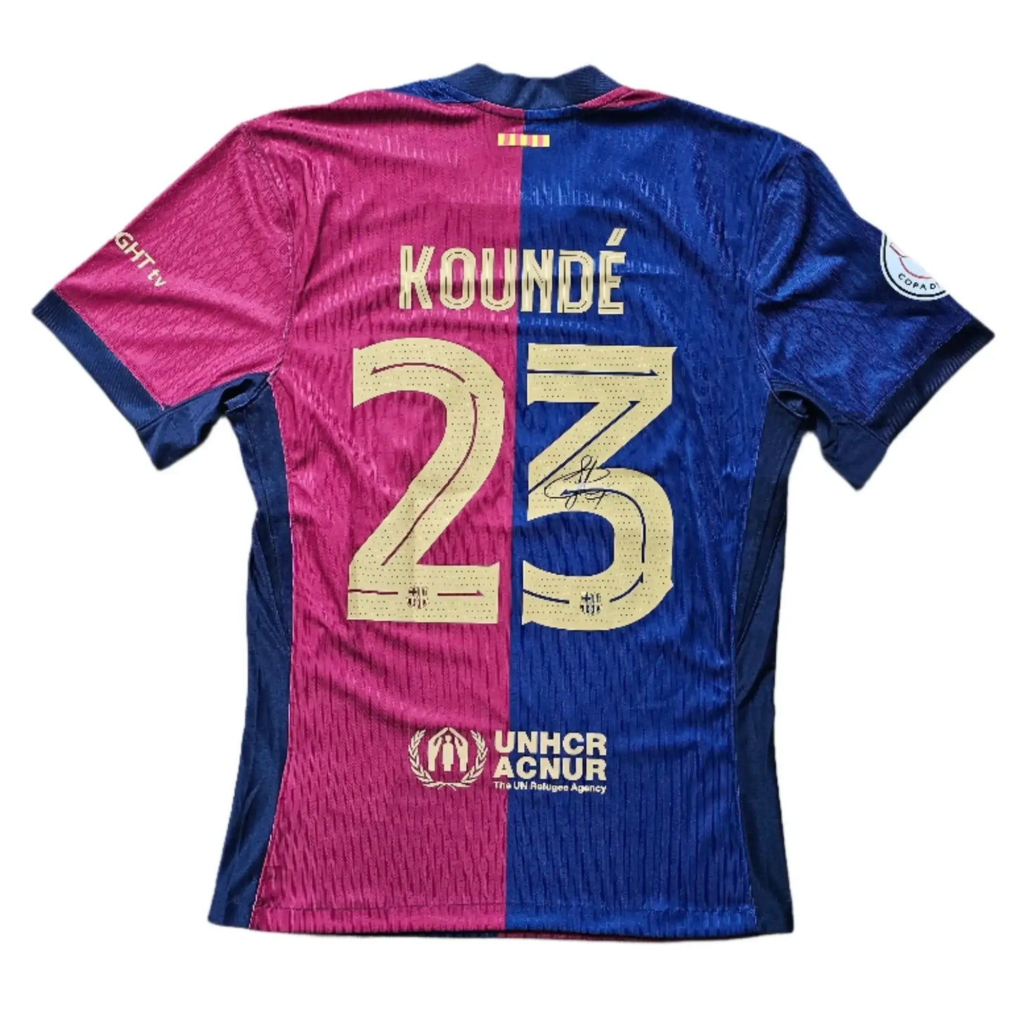 Back view showing KOUNDÉ 23 with signature, featuring blue and red colors.
