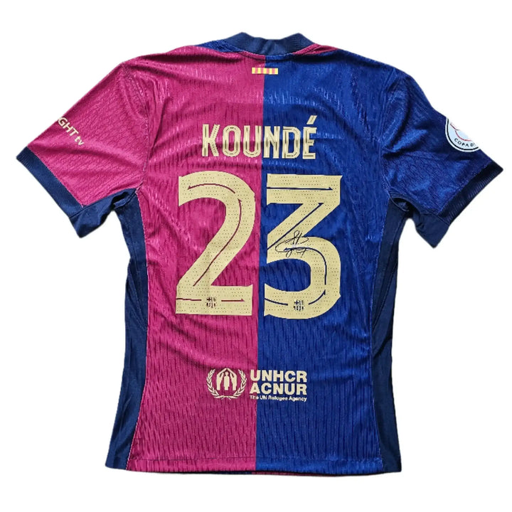 Back view showing KOUNDÉ 23 with signature, featuring blue and red colors.