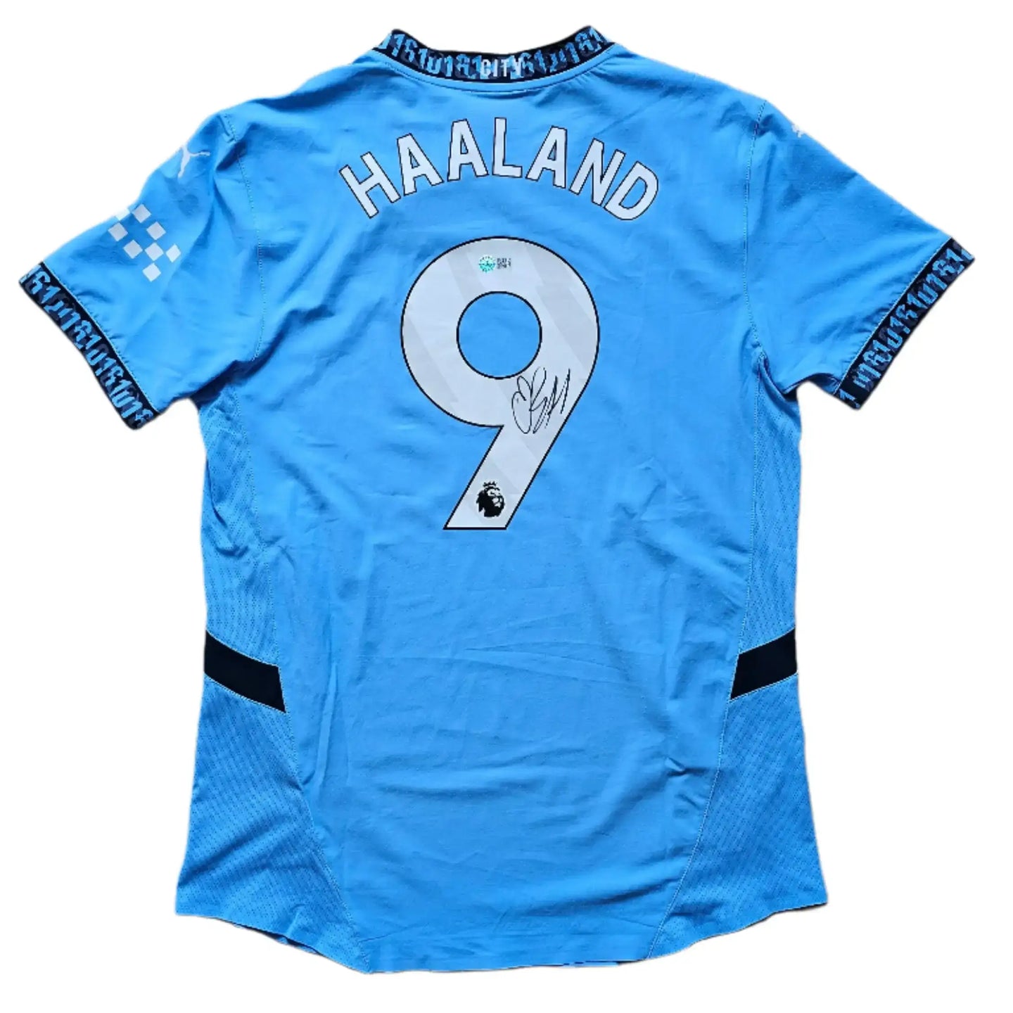 Back view featuring Haaland, No. 9, and a visible signature on a light blue football shirt.