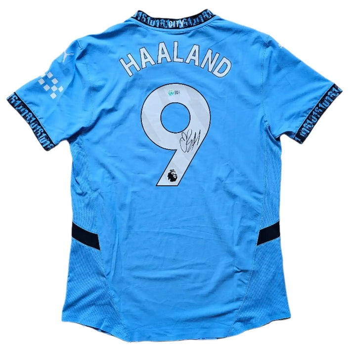 Back view featuring Haaland, No. 9, and a visible signature on a light blue football shirt.