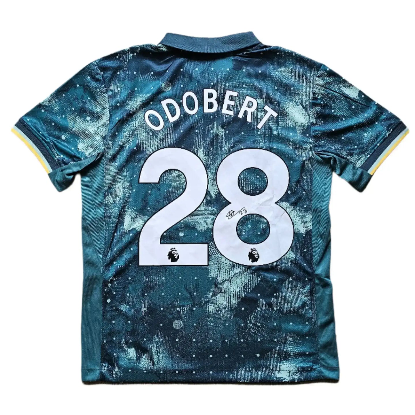 Back view showing Odobert and No. 28 with Premier League logo and signature detail.