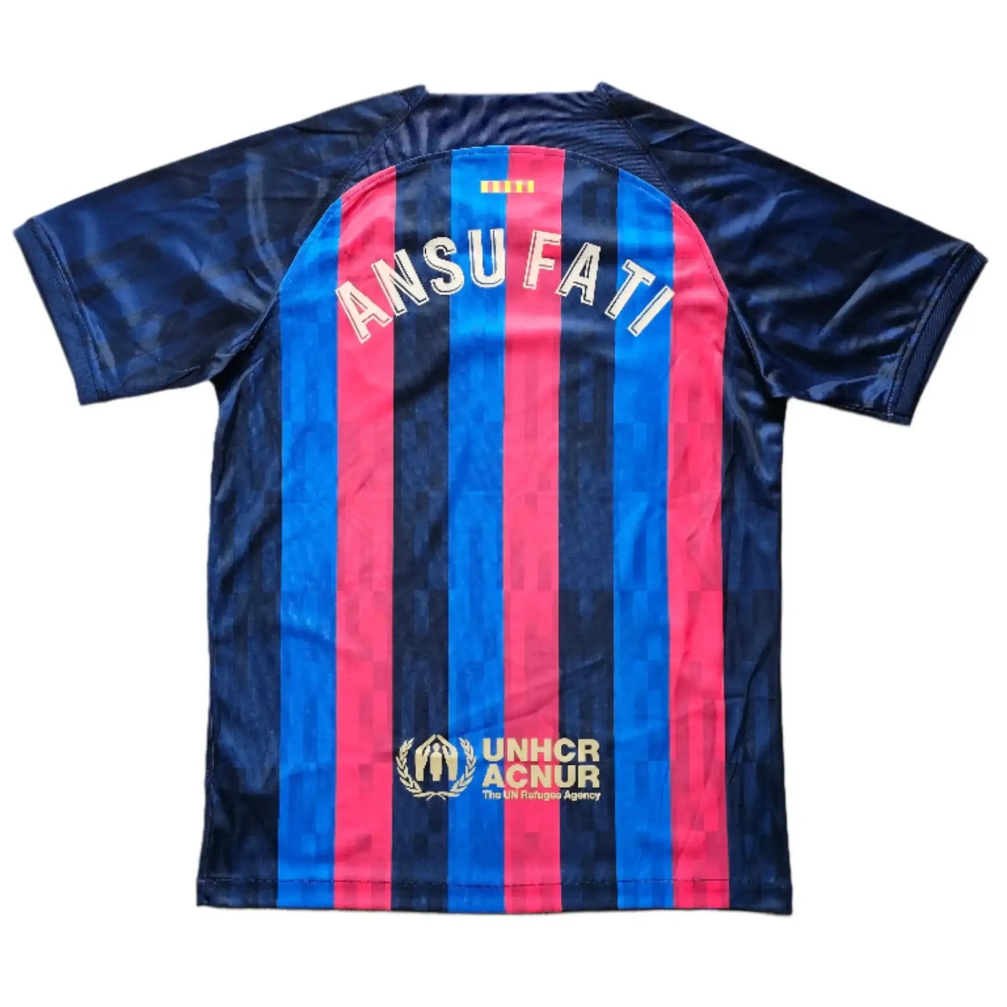 Back view showing name ANSU FATI and UNHCR ACNUR logo on red and blue striped shirt.