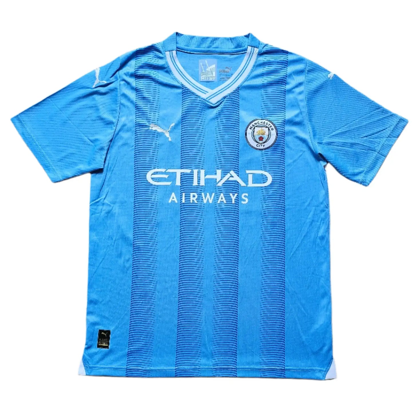 Front view of blue Manchester City football shirt featuring Etihad Airways and club crest.