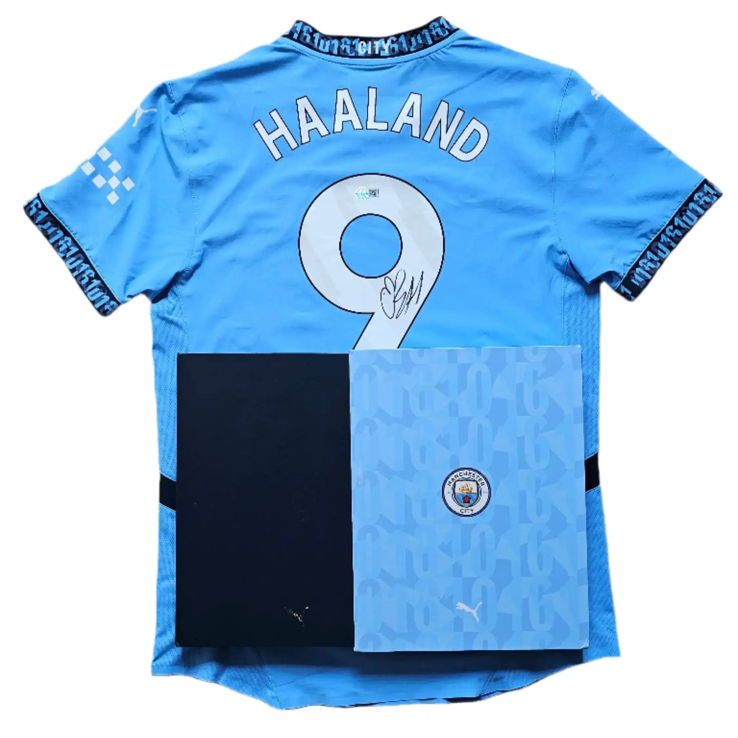 Back view featuring HAALAND, No. 9, and a visible signature with Manchester City branding.