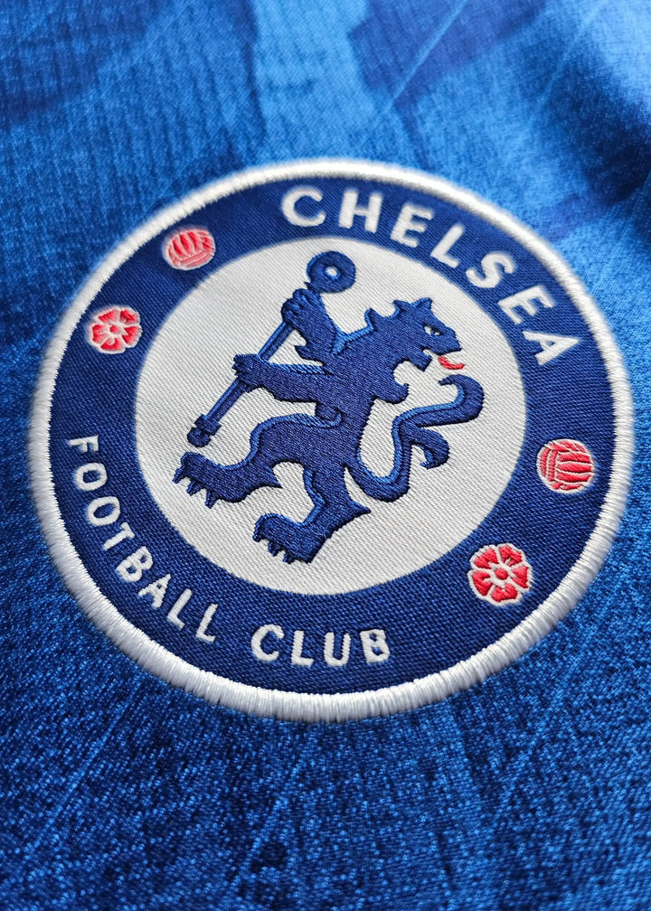 Crest detail of Chelsea Football Club featuring a blue lion and the text &