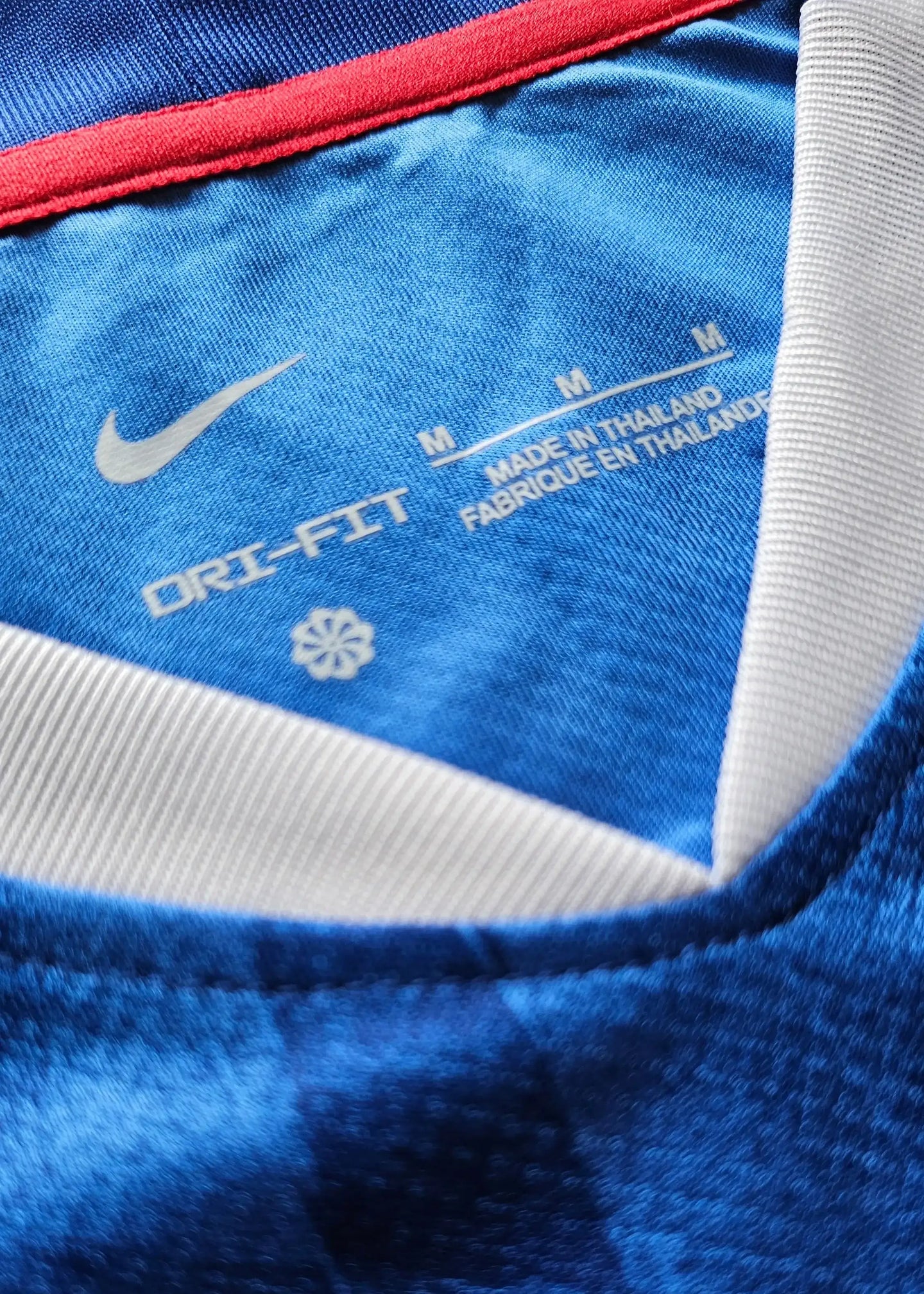 Close-up of the collar showing DRI-FIT and Nike logo, size M, made in Thailand.