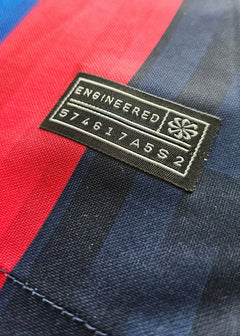 Detail view of Barcelona shirt tag showing 'ENGINEERED' and number '574617A5S2'.