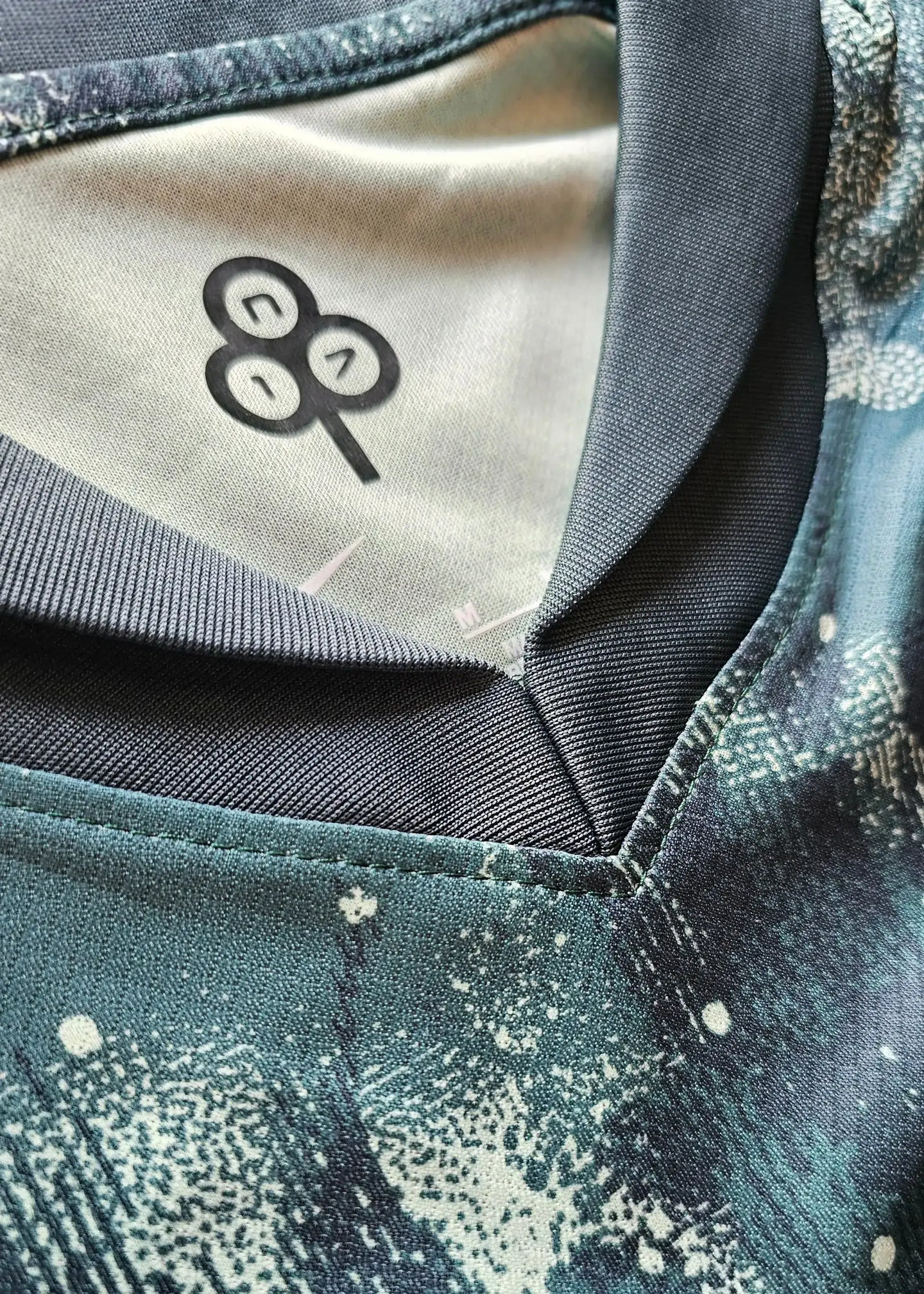 Neckline detail with logo and design of Wilson Odobert 28 Tottenham signed football shirt.