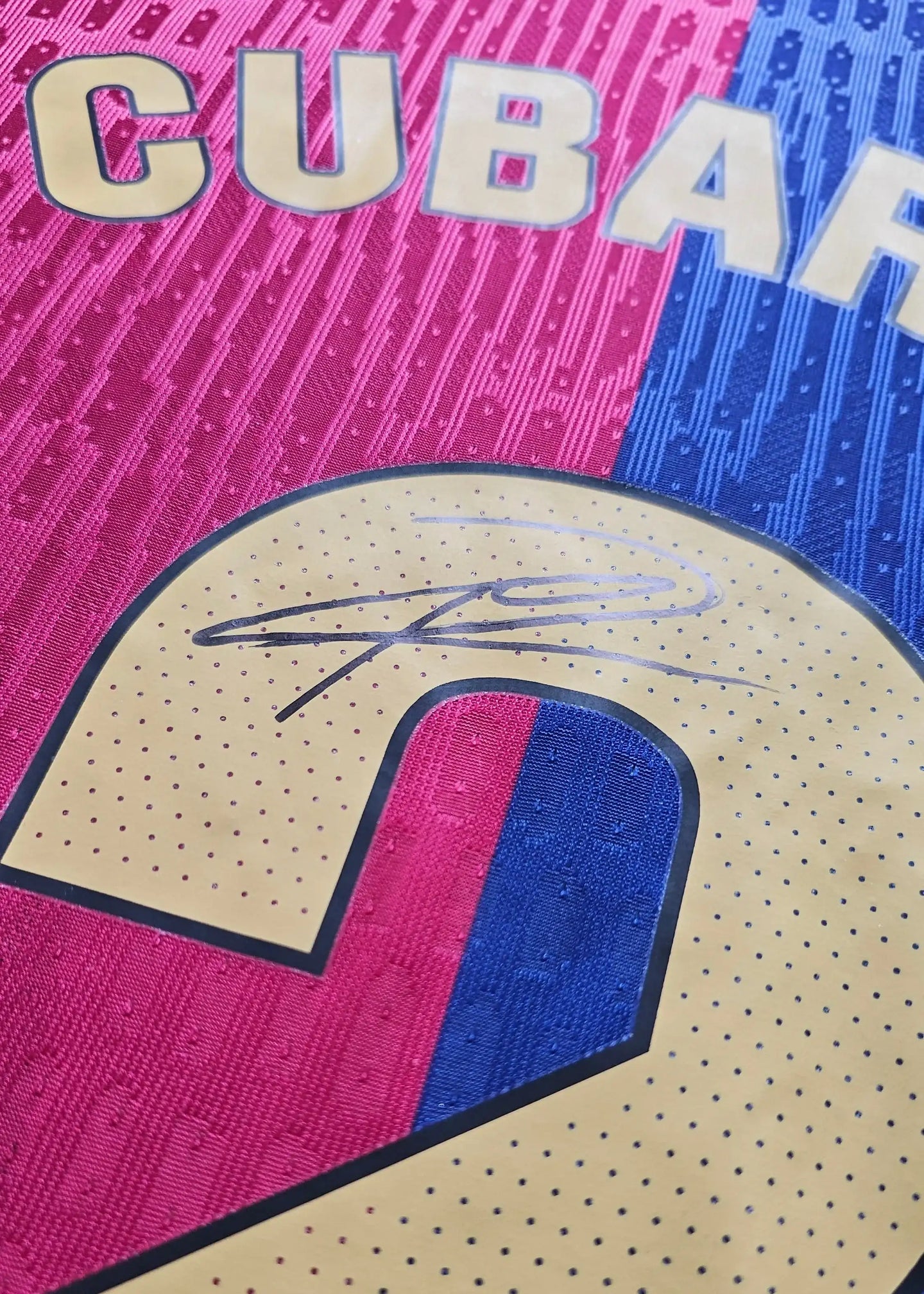 Detail showing signature on No. 2 of Pau Cubarsi Signed Barcelona Football Shirt in pink and blue.