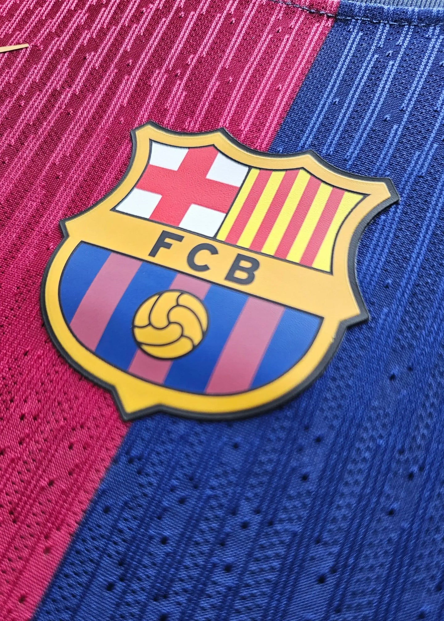 Crest detail of Pau Cubarsi Signed Barcelona Football Shirt featuring FCB emblem.