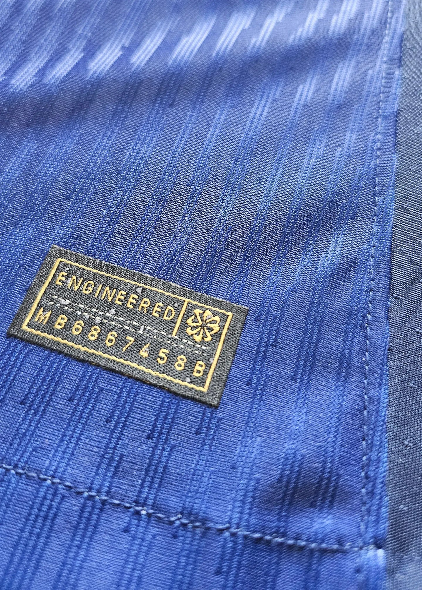 Signature detail on Jules Koundé 23 Barcelona signed shirt, featuring 'ENGINEERED' label.