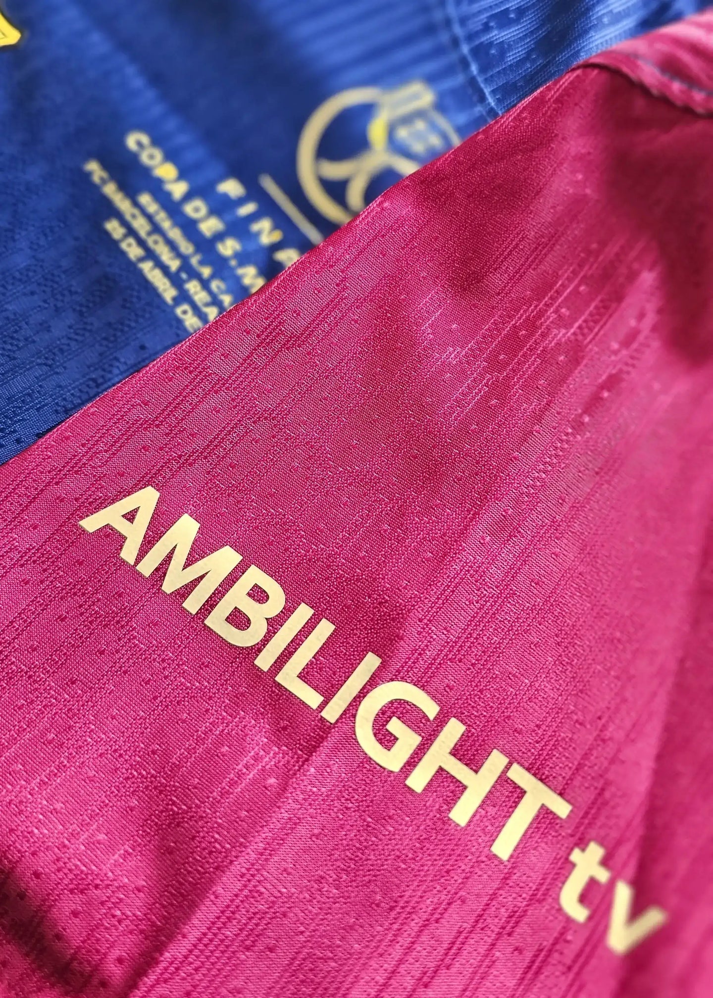 Copa Final badge and Ambilight sponsor text visible on Barcelona shirt's blue and red sections.
