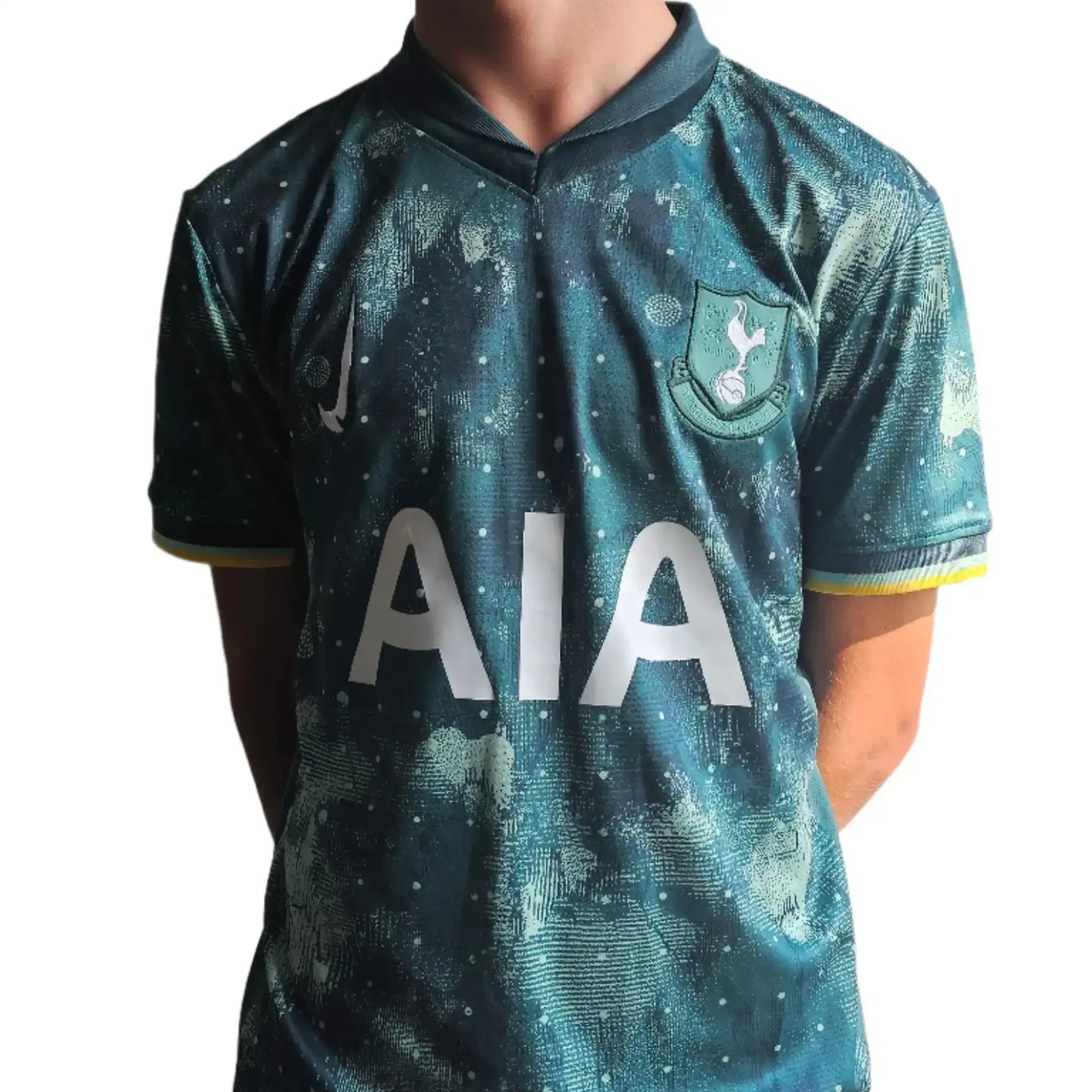 Back view showing Tottenham crest and 'AIA' sponsor text in white on a blue-green football shirt.