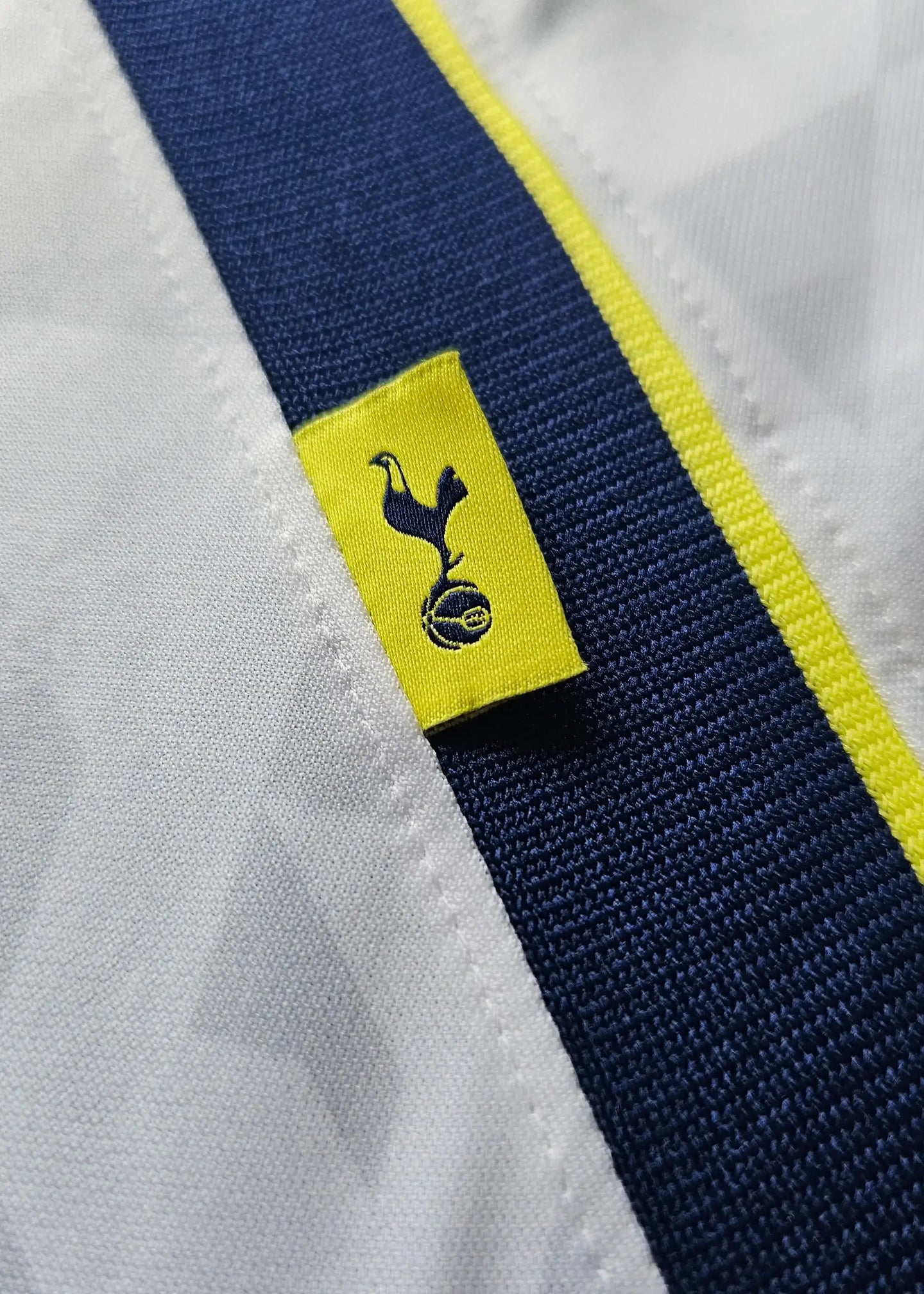 Crest detail with Tottenham Hotspur logo on a white and navy background.