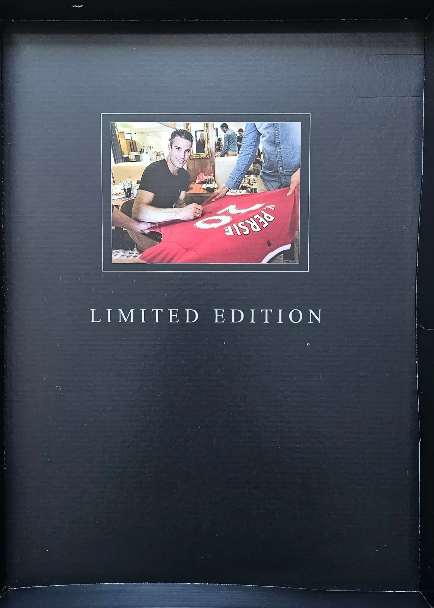 Robin van Persie signing a football shirt featuring No. 20, labeled Limited Edition.