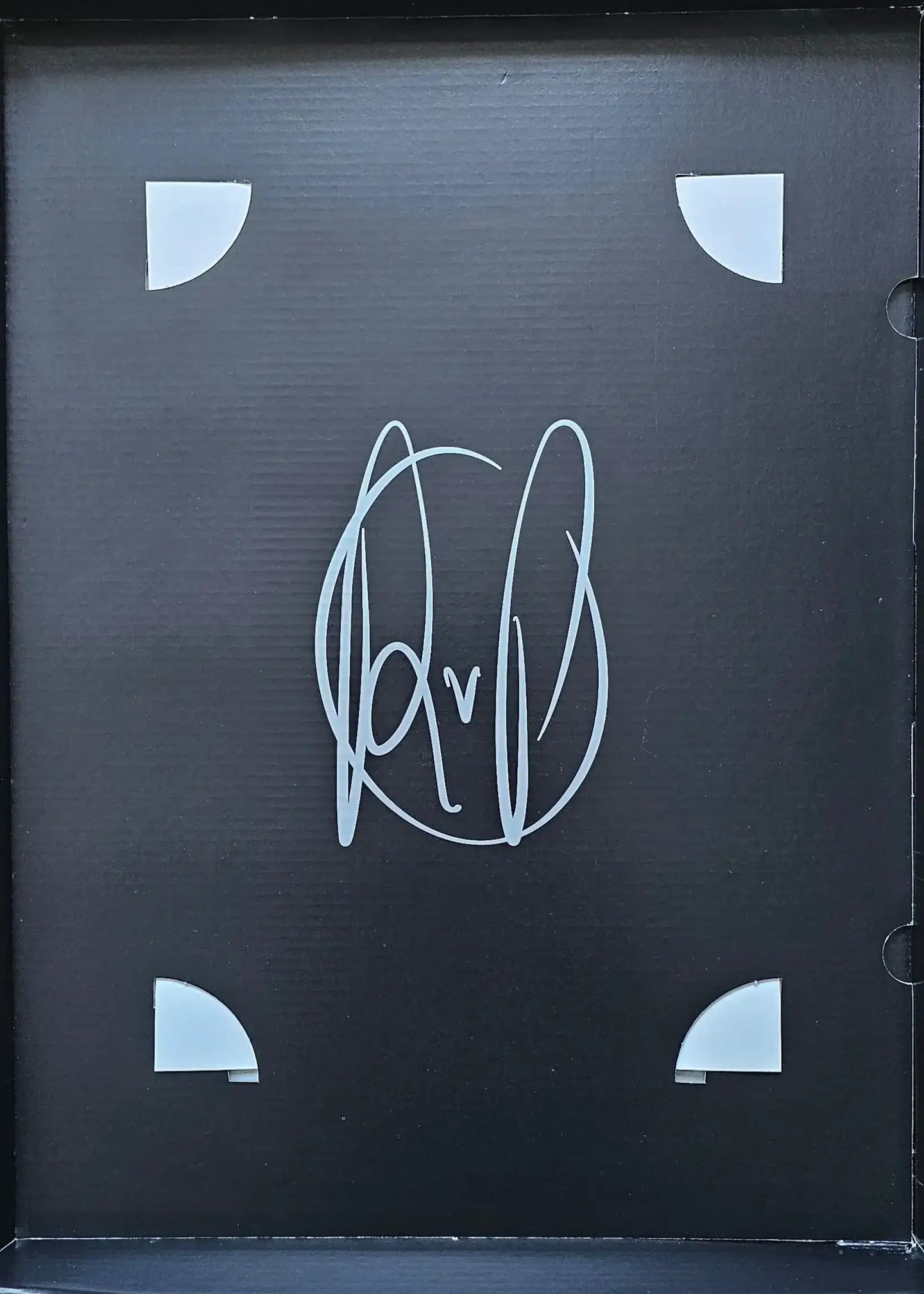 Signature of Robin van Persie in white on a black background with corner protectors.