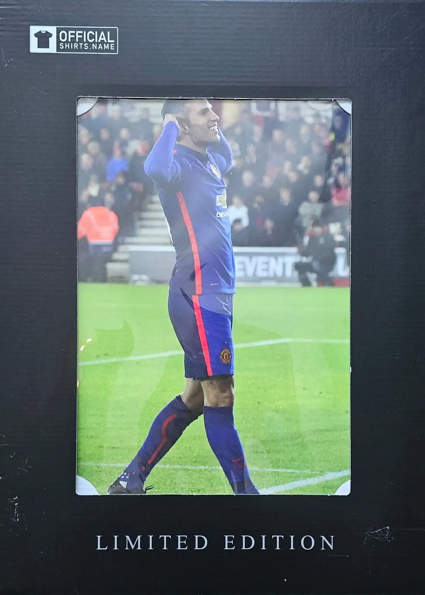 Detail view of Manchester United crest and Limited Edition text on signed football shirt.