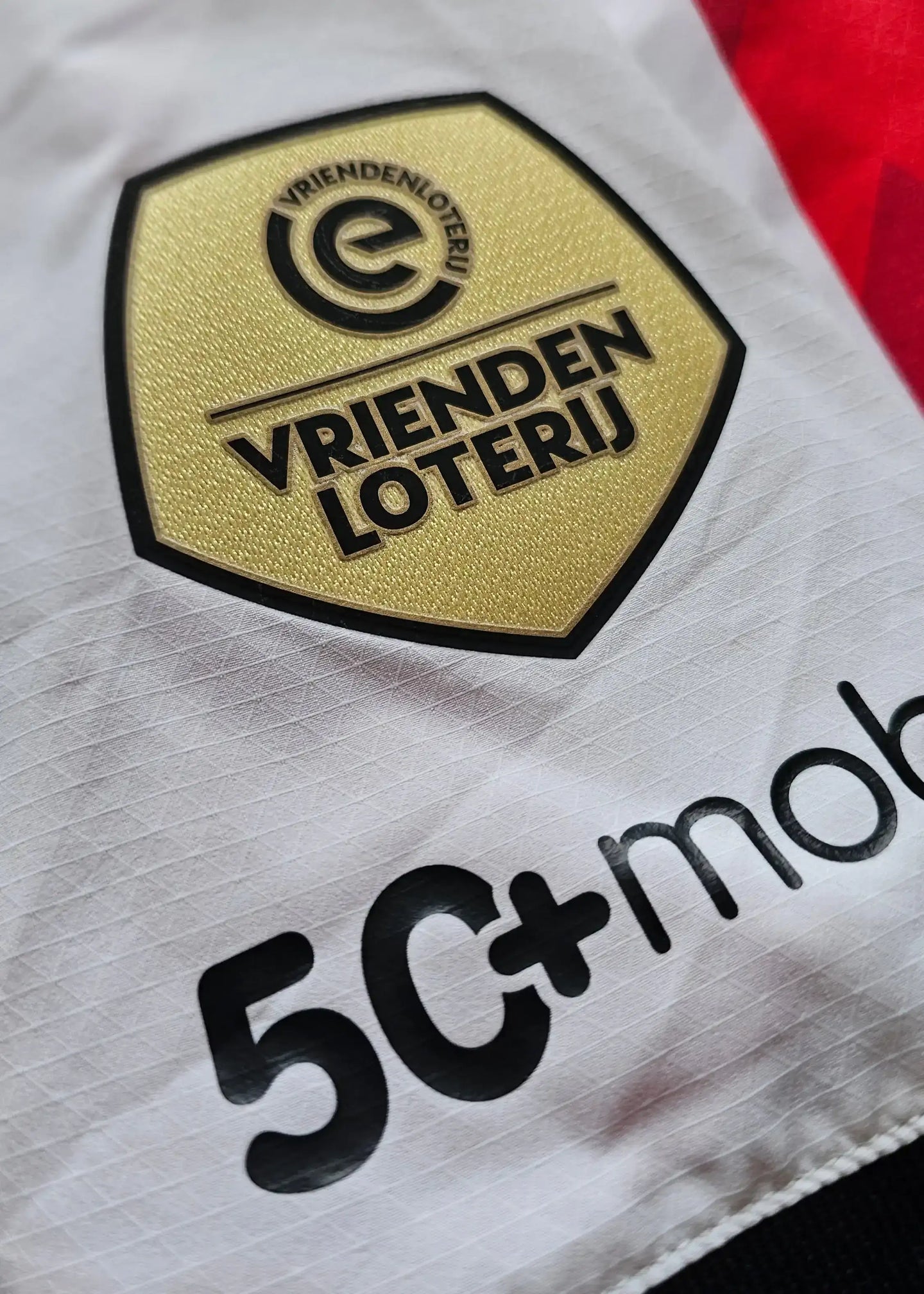 Detail view showing the PSV crest with the text 'VriendenLoterij' and sponsor '5C+mob.'
