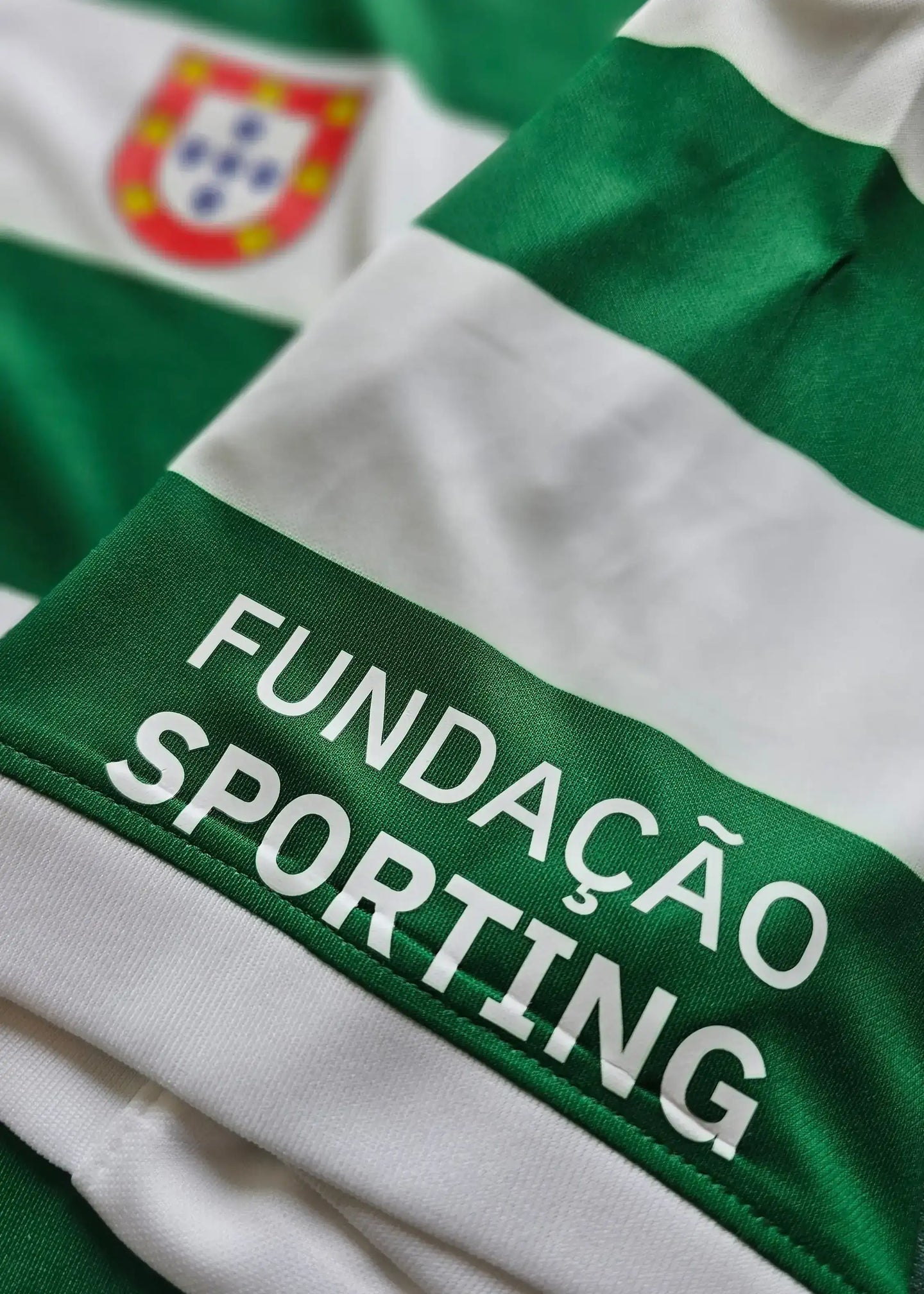 Green and white striped Sporting CP shirt with 'FUNDAÇÃO SPORTING' text on the lower edge.