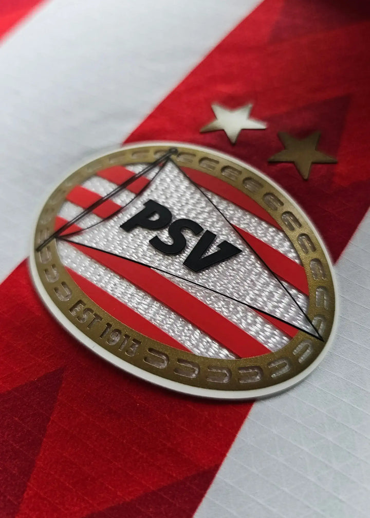 Close-up of PSV crest featuring the text 'PSV' and established year 'EST 1913' with two stars above.