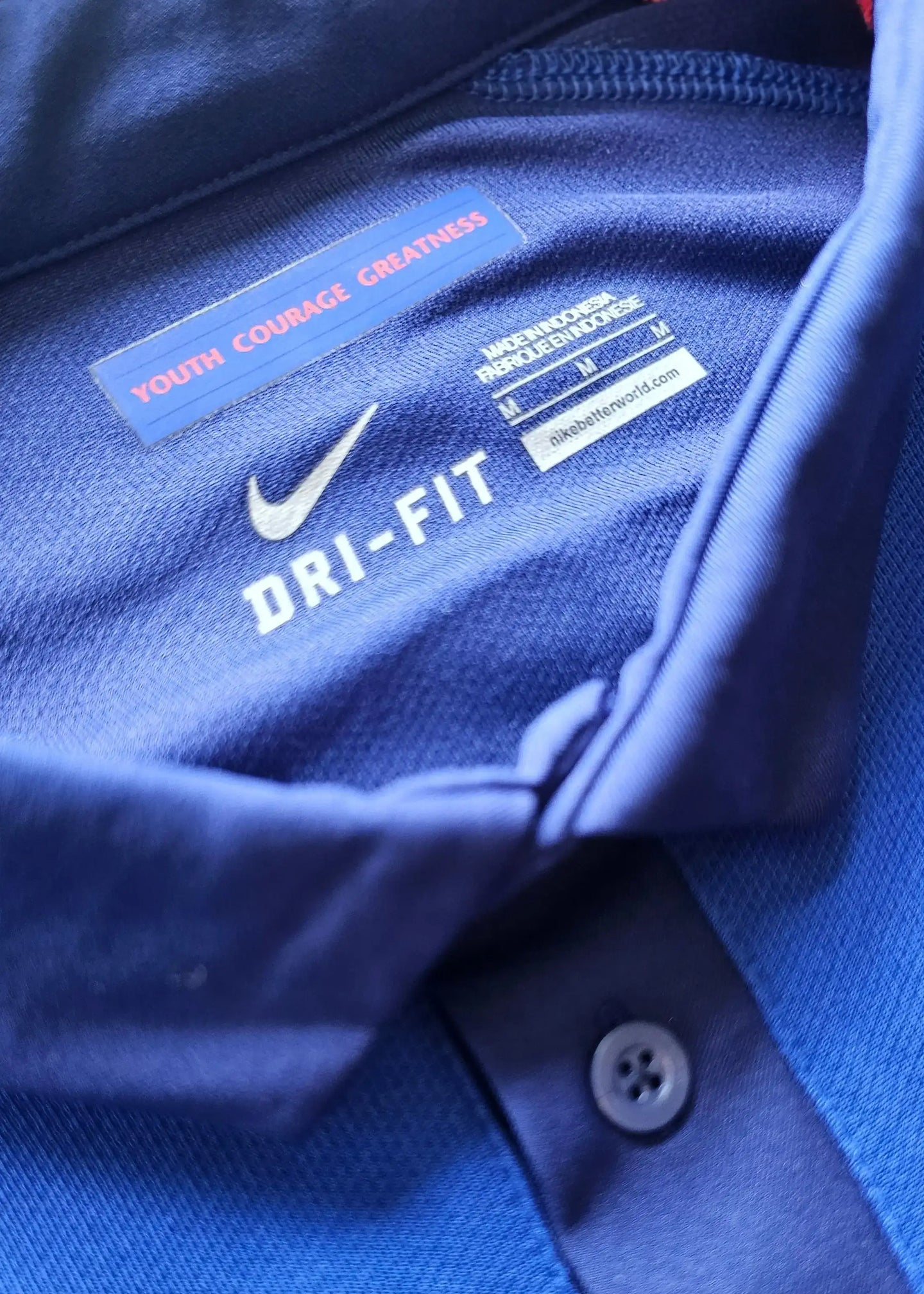 Close-up of collar showing Nike DRI-FIT label and 'YOUTH COURAGE GREATNESS' text.