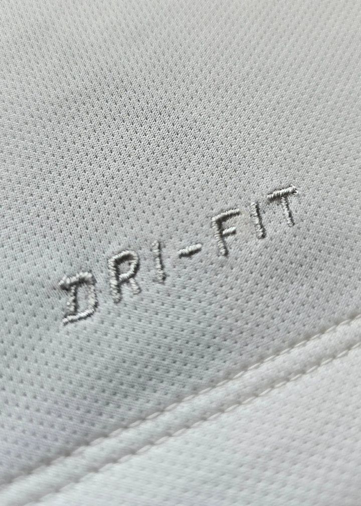 Close-up detail of white fabric featuring &