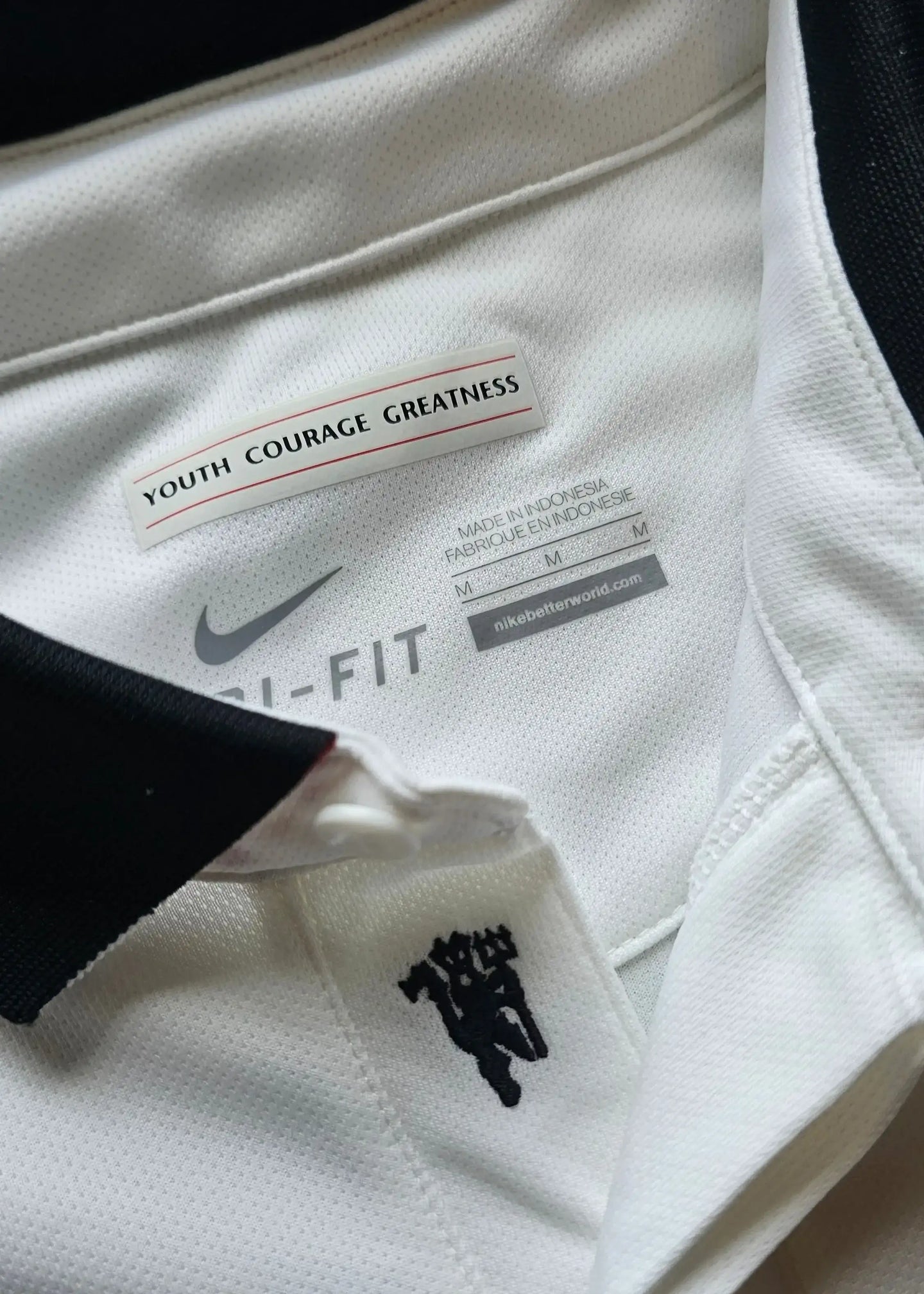 Neck label featuring 'YOUTH COURAGE GREATNESS' and 'Nike Dri-FIT' with black collar.
