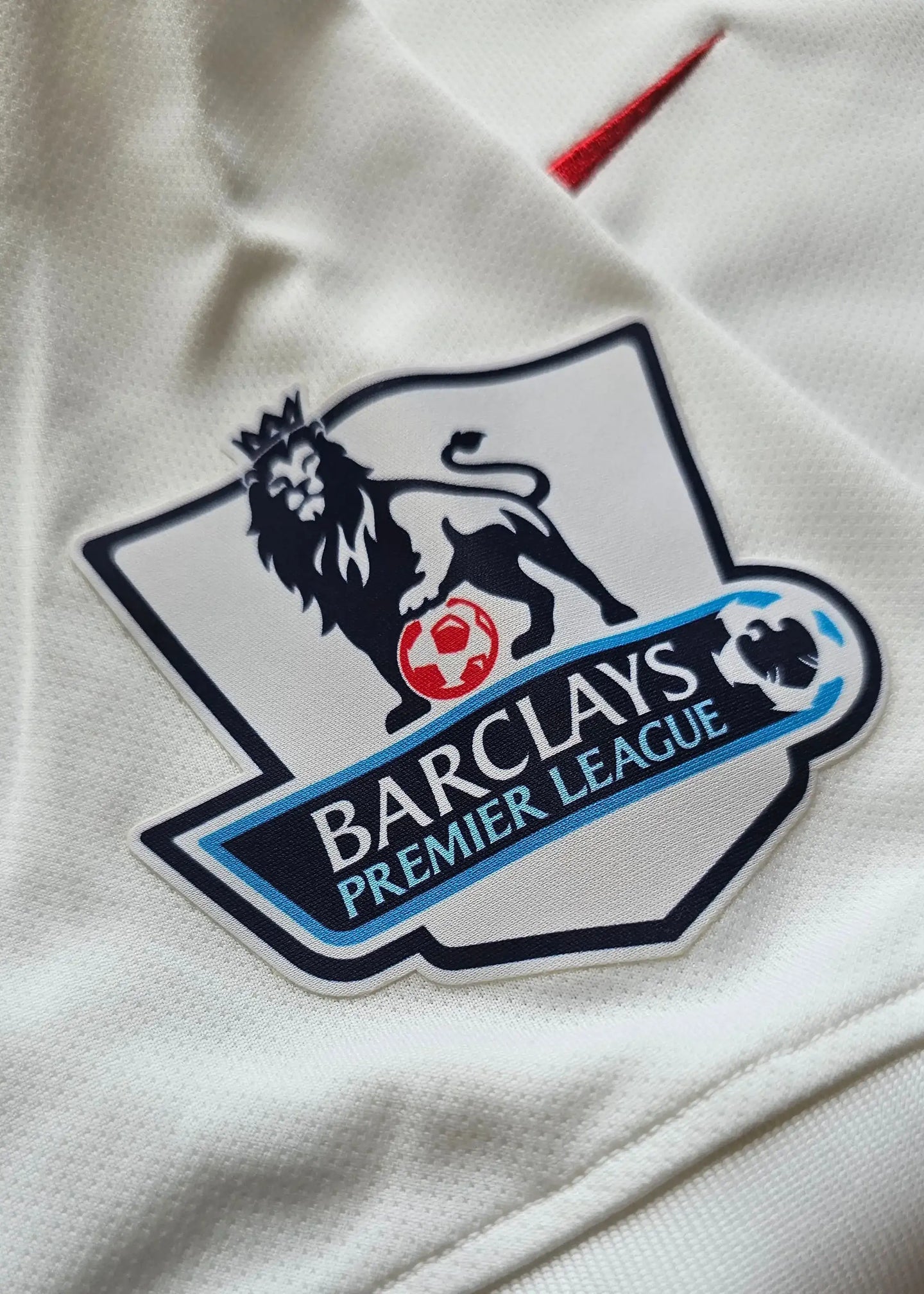 Close-up of the Barclays Premier League crest on a white football shirt.