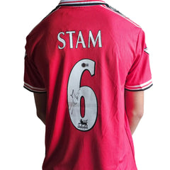 Back view showing No. 6, Stam name, and signature detail on red football shirt.