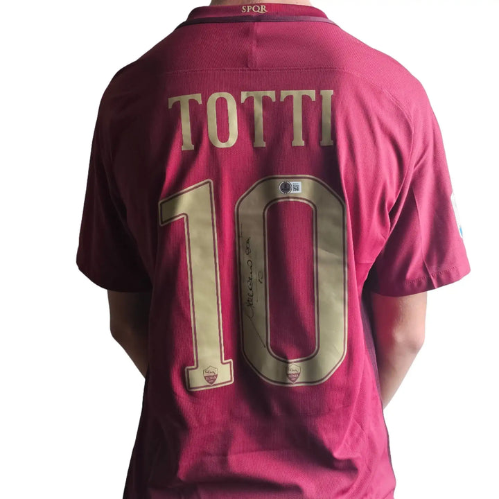 Back view featuring Totti, No. 10, and a visible signature on a red football shirt.