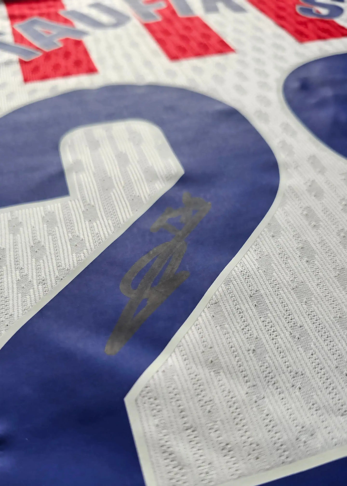 Taufik Seidu No. 28 Atlético Madrid signed detail on a football shirt in red, white, and blue.