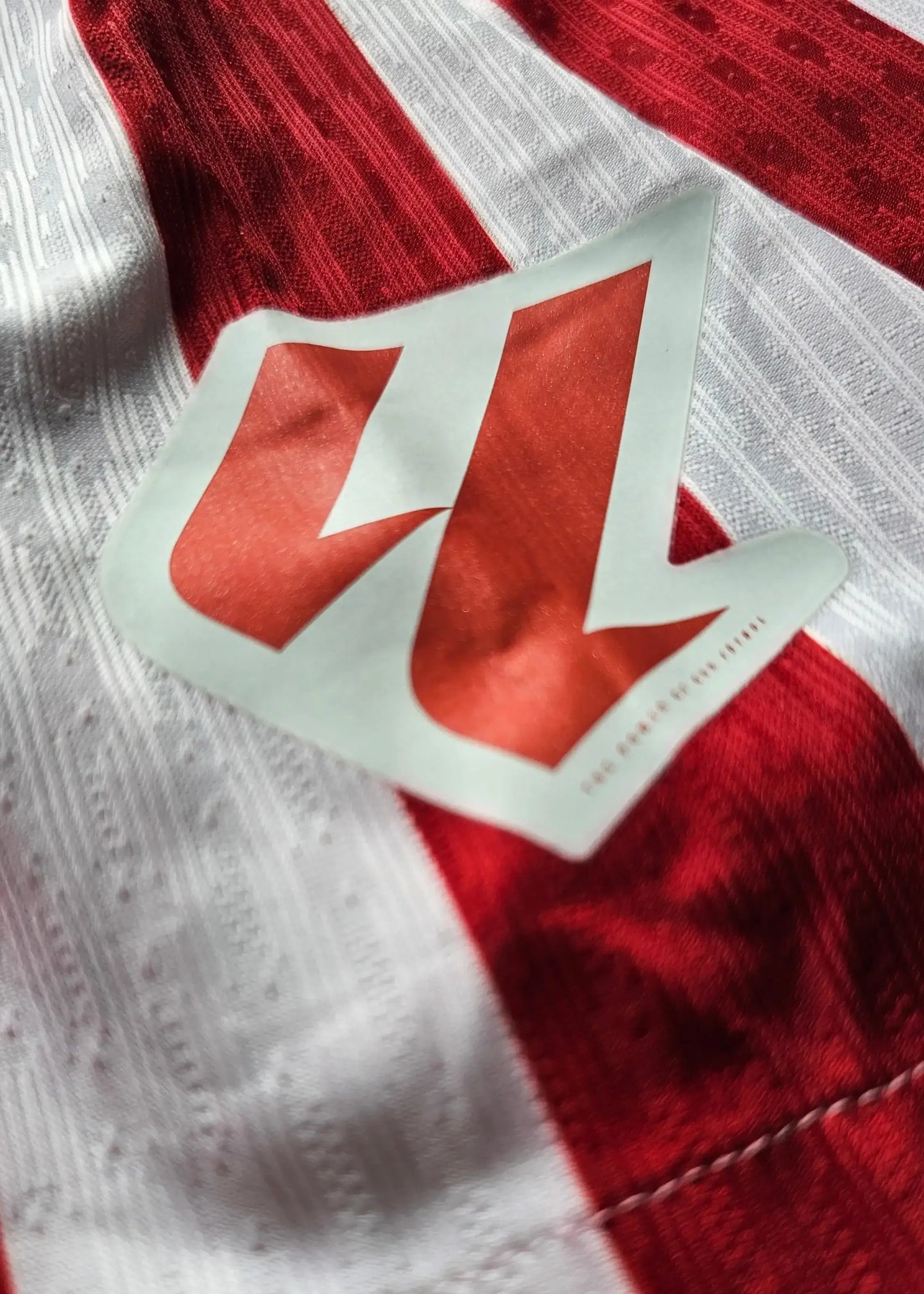 Red and white striped Atlético Madrid shirt with the number 28 and a visible logo detail.