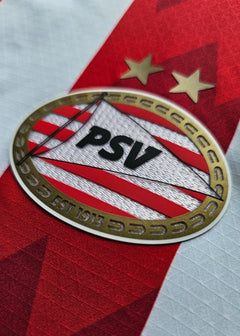 PSV Eindhoven crest with two stars above; established 1913, on a red and white shirt.