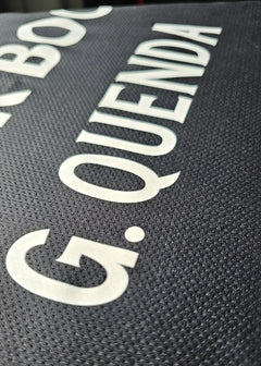 Detail of the name 'G. QUENDA' on a black Sporting CP match-worn shirt.