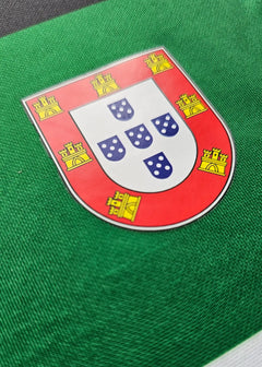 Crest of Portugal featuring five blue shields and yellow castles on a green background.