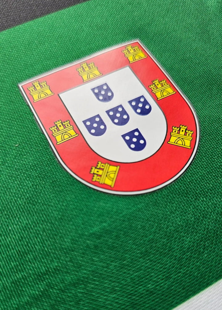 Crest of Portugal featuring five blue shields and yellow castles on a green background.