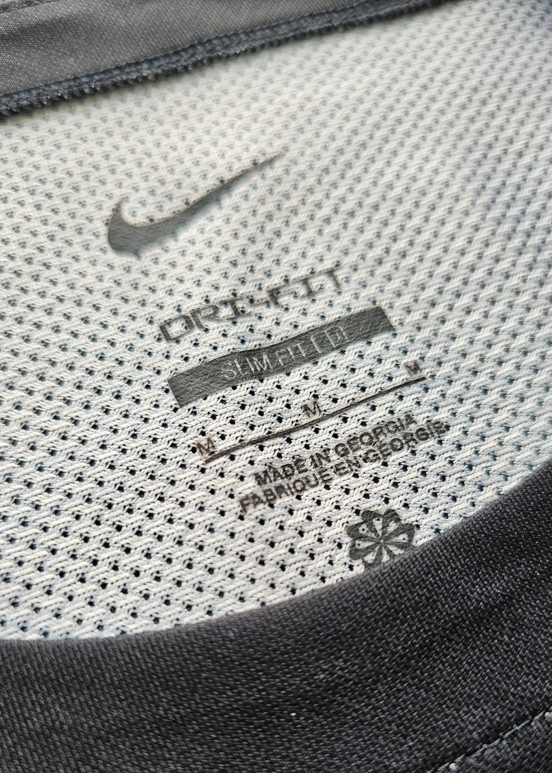 Nike tag detailing with 'DRI-FIT' and care instructions visible on the shirt's inner neck.