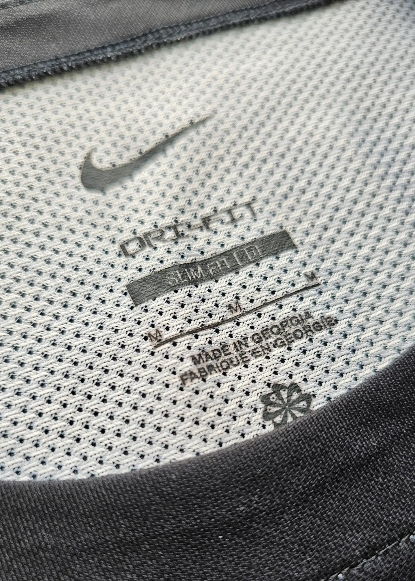 Nike tag detailing with 'DRI-FIT' and care instructions visible on the shirt's inner neck.