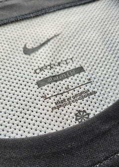 Nike tag detailing with 'DRI-FIT' and care instructions visible on the shirt's inner neck.